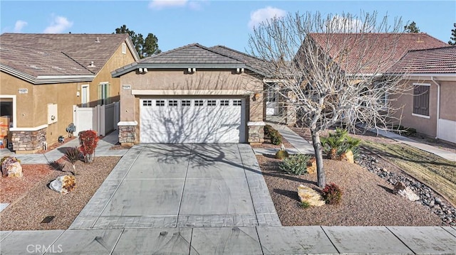 10479 Bridge Haven Rd, Apple Valley, CA 92308 - ranch-style home with driveway, an attached garage, stone siding, and stucco siding