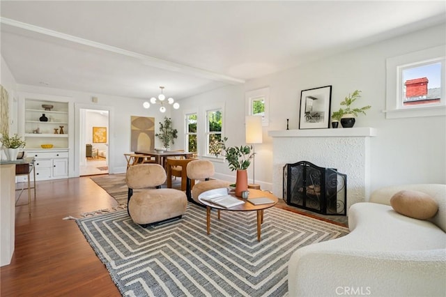 1241 Bresee Ave, Pasadena, CA 91104 - living area featuring wood finished floors, a fireplace, a chandelier, built in shelves, and baseboards