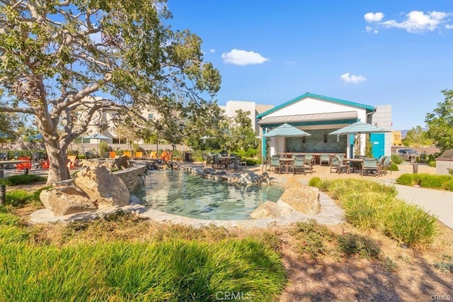 24 Granja Ct, Rancho Mission Viejo, CA 92694 - view of home's community featuring outdoor dining space, a patio area, and a pool