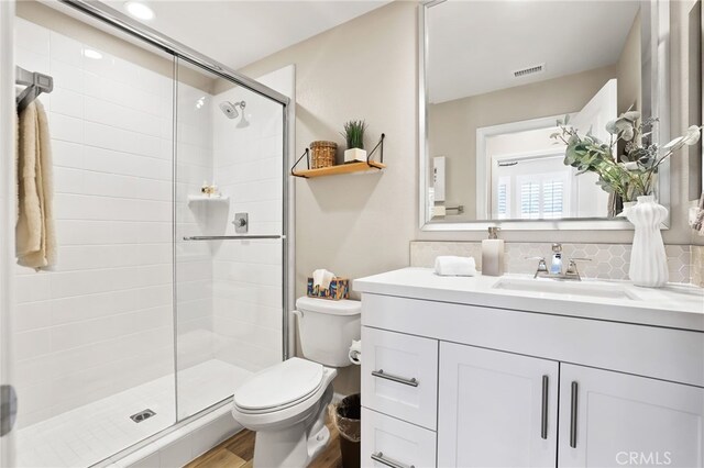 24 Granja Ct, Rancho Mission Viejo, CA 92694 - bathroom with vanity, a shower stall, wood finished floors, and backsplash