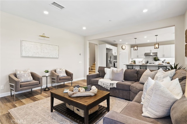24 Granja Ct, Rancho Mission Viejo, CA 92694 - living room featuring recessed lighting, light wood finished floors, and stairs