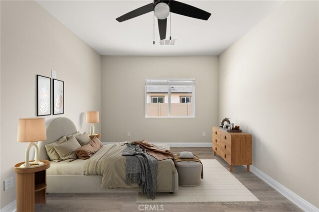 1239 Ansley Ln, Mentone, CA 92359 - bedroom with wood finished floors and a ceiling fan