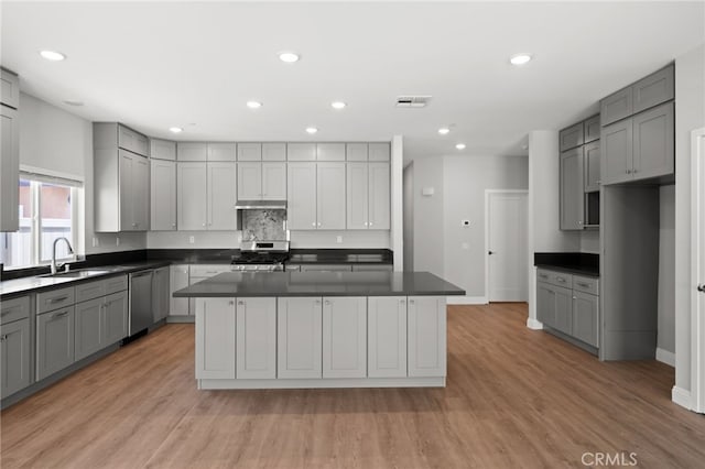 1239 Ansley Ln, Mentone, CA 92359 - kitchen featuring gray cabinetry, stainless steel appliances, dark countertops, light wood finished floors, and recessed lighting
