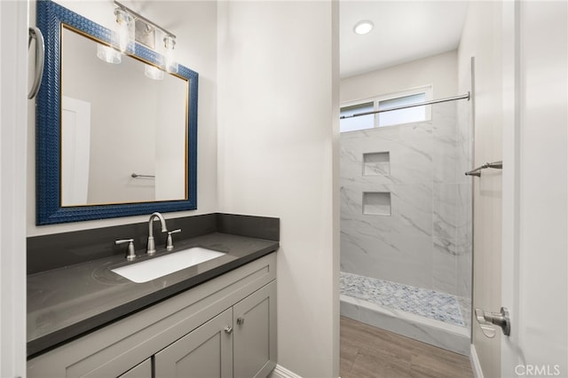 1239 Ansley Ln, Mentone, CA 92359 - bathroom featuring vanity, a marble finish shower, and wood finished floors