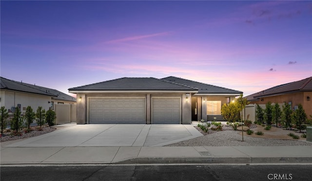 1239 Ansley Ln, Mentone, CA 92359 - ranch-style house with driveway, an attached garage, a tiled roof, and stucco siding