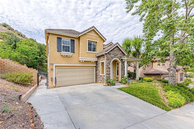 25238 Gloriso Ln, Stevenson Ranch, CA 91381 - view of front of home featuring a garage, concrete driveway, stucco siding, stone siding, and a tiled roof