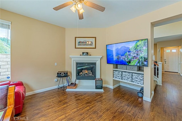 25238 Gloriso Ln, Stevenson Ranch, CA 91381 - living area featuring wood finished floors, a glass covered fireplace, a ceiling fan, and baseboards