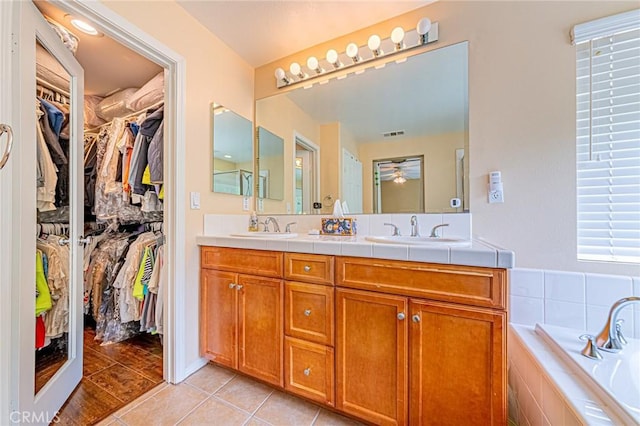 25238 Gloriso Ln, Stevenson Ranch, CA 91381 - full bathroom featuring double vanity, a bath, tile patterned floors, a spacious closet, and a ceiling fan