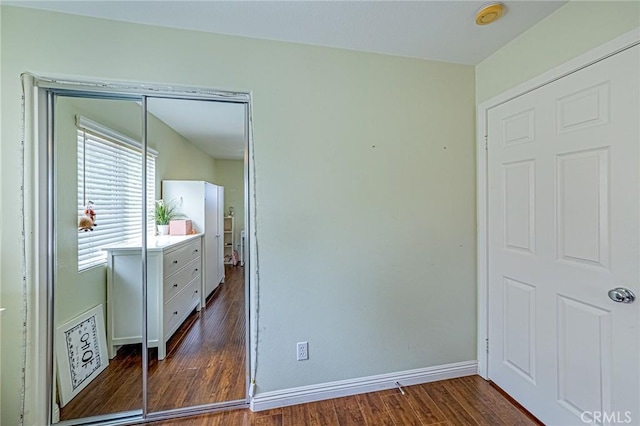 25238 Gloriso Ln, Stevenson Ranch, CA 91381 - bedroom featuring dark wood-type flooring, a closet, and baseboards