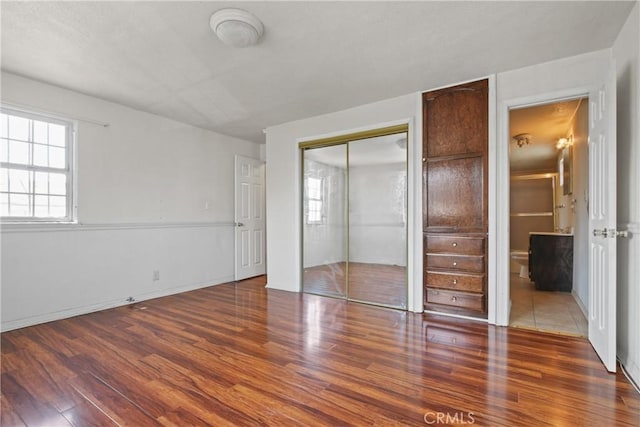 1419 S Redondo Blvd, Los Angeles, CA 90019 - unfurnished bedroom featuring wood finished floors, a closet, and baseboards