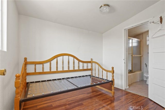 1419 S Redondo Blvd, Los Angeles, CA 90019 - bedroom featuring wood finished floors, baseboards, and ensuite bath