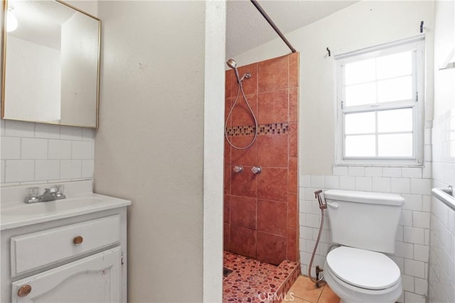 1419 S Redondo Blvd, Los Angeles, CA 90019 - full bath featuring toilet, a tile shower, tile walls, vanity, and tile patterned floors