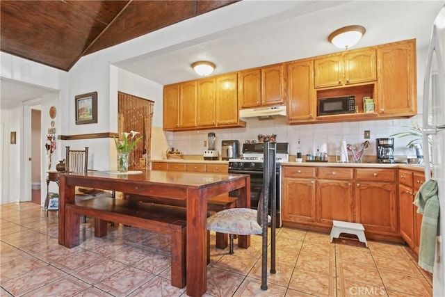 1419 S Redondo Blvd, Los Angeles, CA 90019 - kitchen with under cabinet range hood, black microwave, gas stove, tasteful backsplash, and lofted ceiling