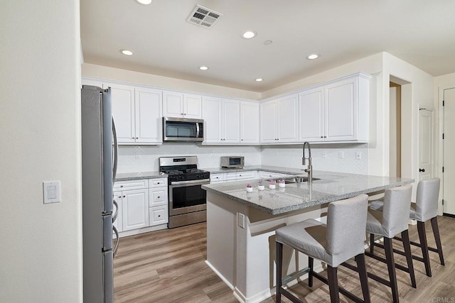 1923 Corte Zafiro Unit 170, Chula Vista, CA 91913 - kitchen with appliances with stainless steel finishes, a sink, white cabinets, backsplash, and recessed lighting