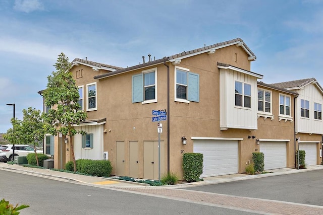 1923 Corte Zafiro Unit 170, Chula Vista, CA 91913 - view of property featuring stucco siding and an attached garage
