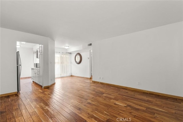 7641 Reseda Blvd Unit 108Z, Reseda, CA 91335 - unfurnished room featuring wood finished floors and baseboards