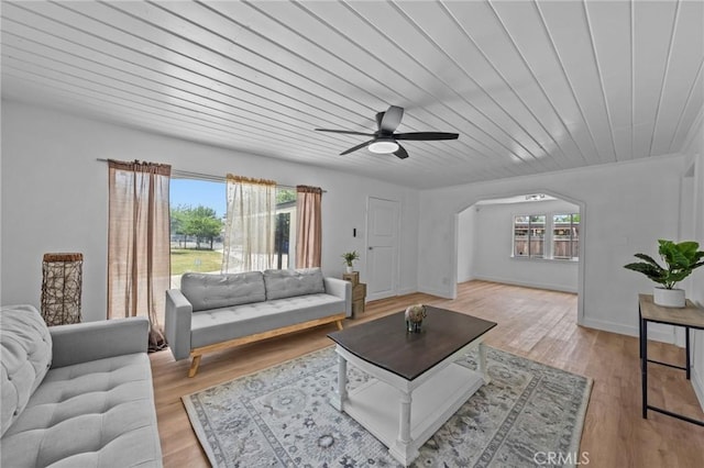 24576 4th St, San Bernardino, CA 92410 - living area featuring arched walkways, a ceiling fan, light wood-type flooring, and wood ceiling