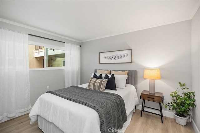 3241 San Amadeo Unit 1G, Laguna Woods, CA 92637 - bedroom featuring ornamental molding, wood finished floors, and baseboards