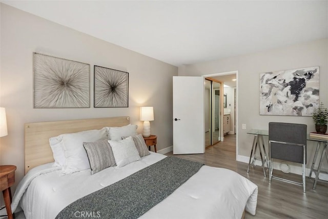 3241 San Amadeo Unit 1G, Laguna Woods, CA 92637 - bedroom with wood finished floors and baseboards