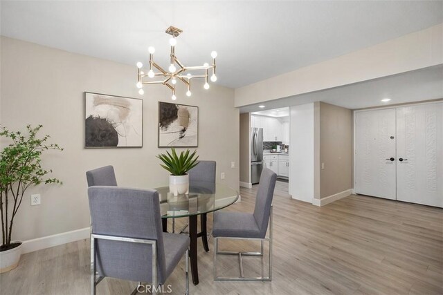 3241 San Amadeo Unit 1G, Laguna Woods, CA 92637 - dining space featuring baseboards, light wood-type flooring, a chandelier, and recessed lighting