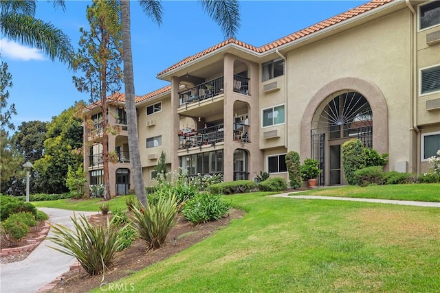 3241 San Amadeo Unit 1G, Laguna Woods, CA 92637 - view of apartment building / complex featuring a wall unit AC