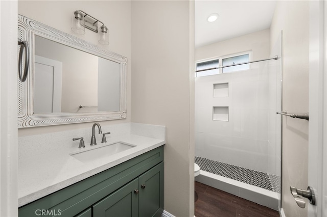 1243 Ansley Ln, Mentone, CA 92359 - bathroom featuring a tile shower, vanity, and wood finished floors