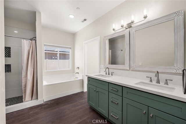 1243 Ansley Ln, Mentone, CA 92359 - bathroom featuring a stall shower, wood finished floors, double vanity, a bath, and recessed lighting