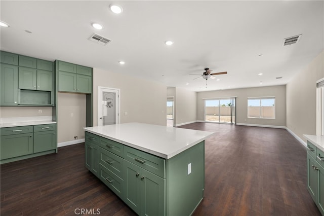 1243 Ansley Ln, Mentone, CA 92359 - kitchen with green cabinets, a ceiling fan, dark wood-style flooring, recessed lighting, and light countertops