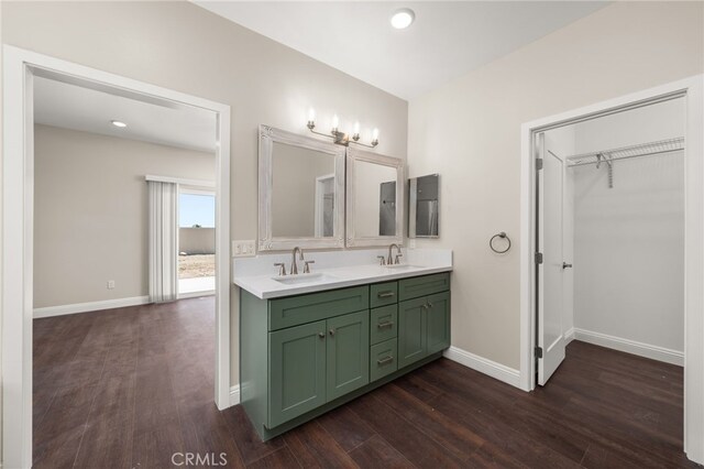 1243 Ansley Ln, Mentone, CA 92359 - full bath featuring double vanity, wood finished floors, a spacious closet, and recessed lighting