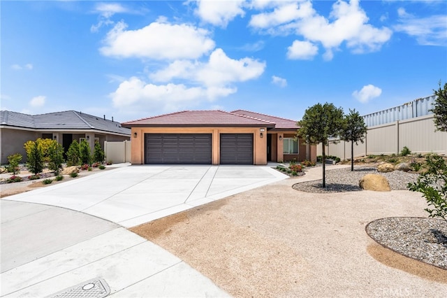 1243 Ansley Ln, Mentone, CA 92359 - view of front of home with a tile roof, a garage, concrete driveway, and stucco siding