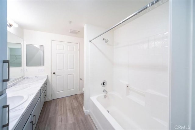 31241 Taylor Ln, Temecula, CA 92592 - bathroom featuring double vanity, shower / washtub combination, and wood finished floors