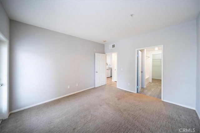 31241 Taylor Ln, Temecula, CA 92592 - unfurnished bedroom featuring light colored carpet, baseboards, and a walk in closet