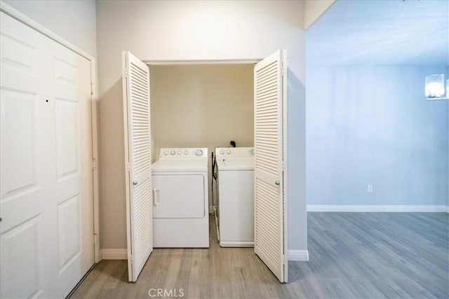 31241 Taylor Ln, Temecula, CA 92592 - washroom with washer and dryer, light wood-type flooring, and baseboards