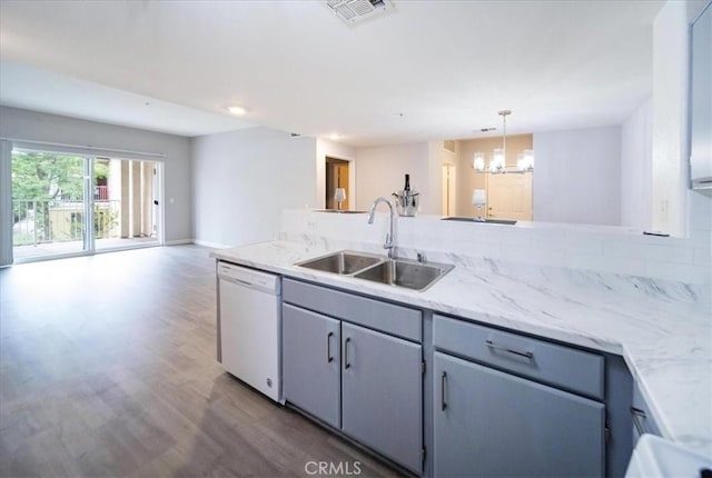31241 Taylor Ln, Temecula, CA 92592 - kitchen with white dishwasher, a sink, a chandelier, wood finished floors, and open floor plan