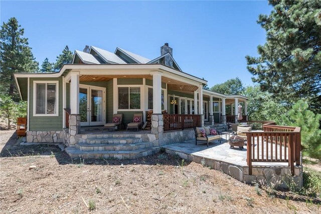 32557 Pine Cone Ct Unit A & B, Running Springs, CA 92382 - back of house with an outdoor fire pit, french doors, a chimney, and a patio