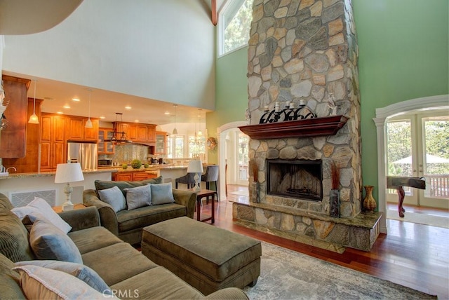 32557 Pine Cone Ct Unit A & B, Running Springs, CA 92382 - living area featuring a high ceiling, wood finished floors, and a stone fireplace