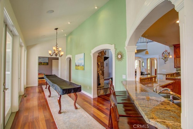 32557 Pine Cone Ct Unit A & B, Running Springs, CA 92382 - hall with arched walkways, a sink, plenty of natural light, wood-type flooring, and a towering ceiling