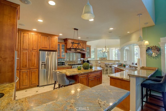 32557 Pine Cone Ct Unit A & B, Running Springs, CA 92382 - kitchen with appliances with stainless steel finishes, brown cabinetry, a kitchen breakfast bar, glass insert cabinets, and recessed lighting