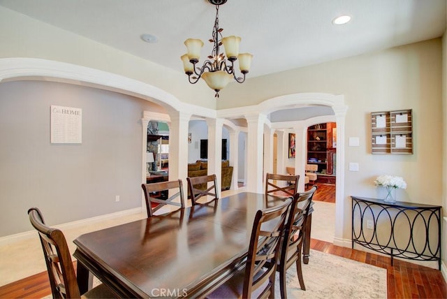32557 Pine Cone Ct Unit A & B, Running Springs, CA 92382 - dining room with arched walkways, decorative columns, a chandelier, wood finished floors, and recessed lighting
