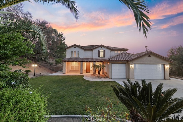 12830 Wildflower Ln, Riverside, CA 92503 - mediterranean / spanish house with a garage, concrete driveway, stucco siding, a porch, and a tiled roof