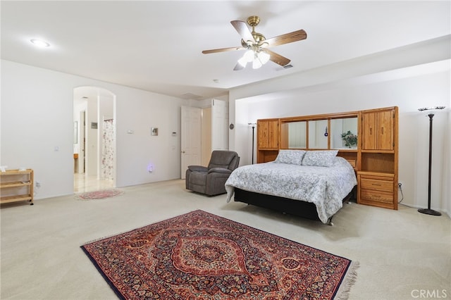 12830 Wildflower Ln, Riverside, CA 92503 - bedroom featuring light carpet, arched walkways, and ceiling fan