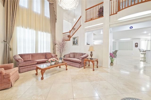 12830 Wildflower Ln, Riverside, CA 92503 - living area with a towering ceiling, stairs, a chandelier, and tile patterned flooring