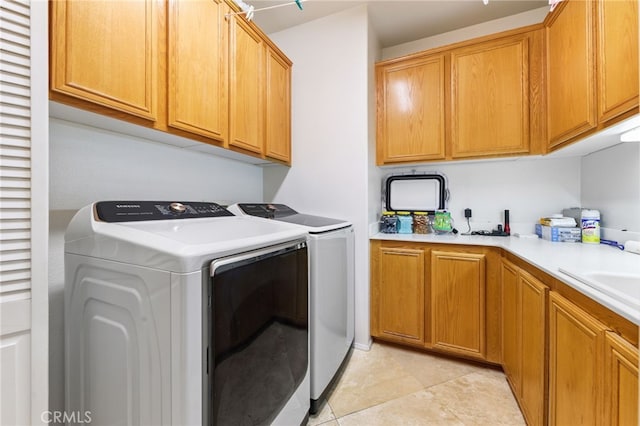 12830 Wildflower Ln, Riverside, CA 92503 - washroom with washer and dryer, cabinet space, and light tile patterned floors