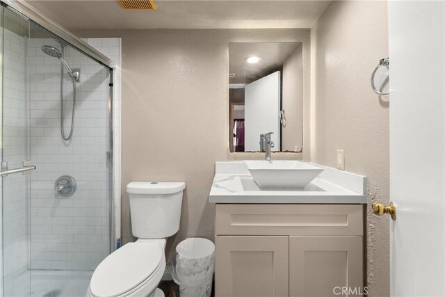 1149 Cochise Ct, Vista, CA 92084 - bathroom featuring vanity, toilet, a shower stall, and a textured wall