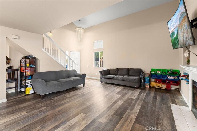 1149 Cochise Ct, Vista, CA 92084 - living area with stairs, wood finished floors, a tiled fireplace, and baseboards
