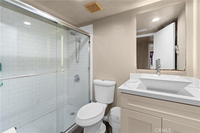 1149 Cochise Ct, Vista, CA 92084 - bathroom featuring toilet, vanity, a shower stall, a textured wall, and recessed lighting