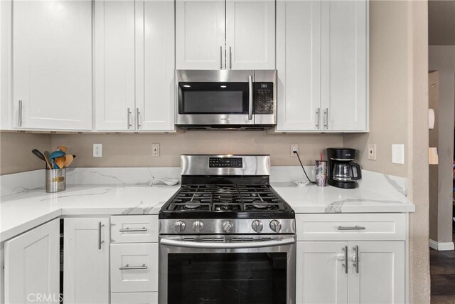 1149 Cochise Ct, Vista, CA 92084 - kitchen featuring appliances with stainless steel finishes, white cabinetry, and light stone counters