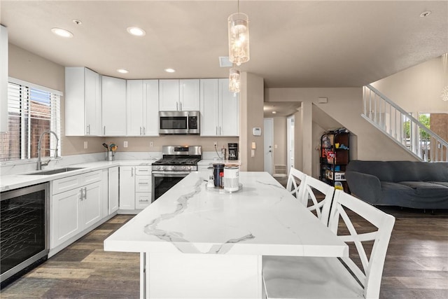 1149 Cochise Ct, Vista, CA 92084 - kitchen with appliances with stainless steel finishes, a sink, wine cooler, a center island, and dark wood finished floors