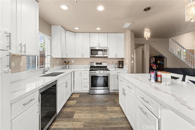 1149 Cochise Ct, Vista, CA 92084 - kitchen with stainless steel appliances, beverage cooler, a sink, recessed lighting, and white cabinetry
