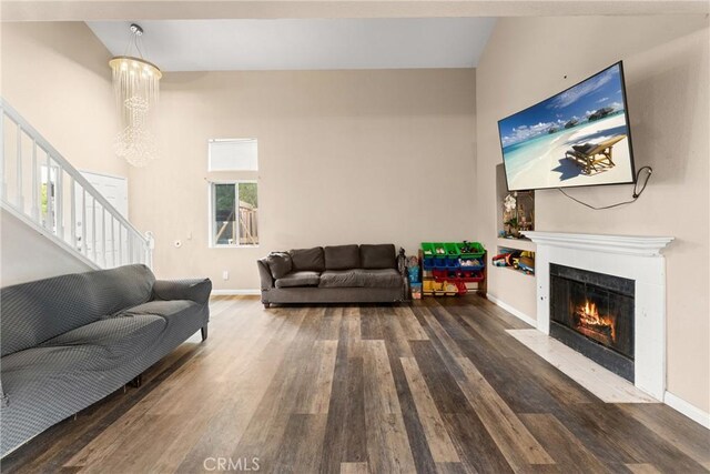 1149 Cochise Ct, Vista, CA 92084 - living area with wood finished floors, stairs, a fireplace, and a chandelier